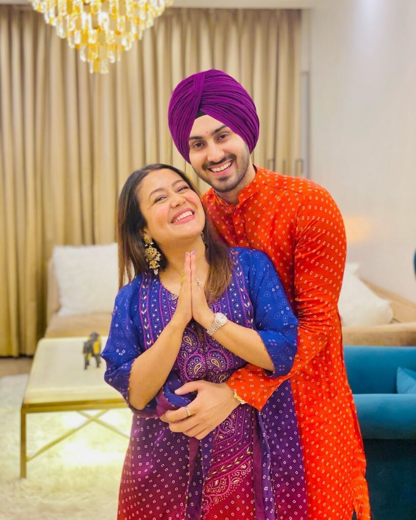 Neha Kakkar in multicolor suit and Rohanpreet Singh in orange traditional\ kurta - indian celebrity couples big age difference