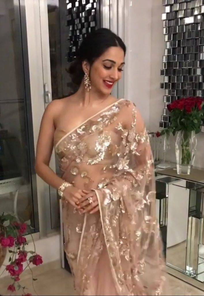 Kiara Advani in peach saree and Messy bun with bangs - woman hair care regime
