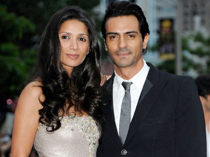 Arjun Rampal in black suit and Mehr Jesia in silver shimmery dress posing for camera - celebrity couple big age gap