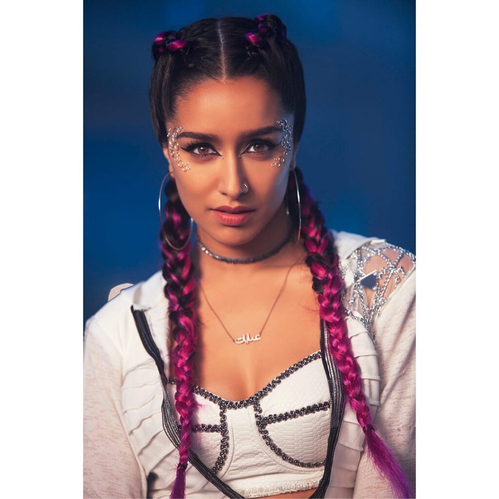Shraddha Kapoor in pink color 2 braid hairstyle posing for camera - woman hair care regime