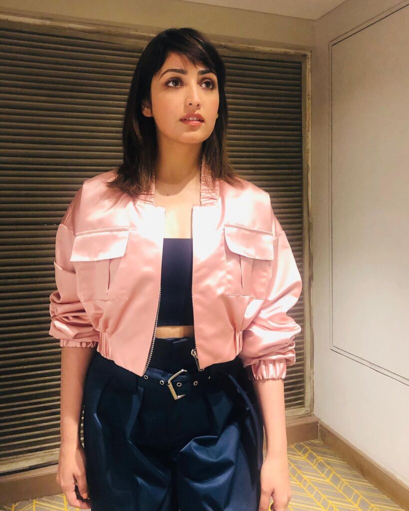Yami Gautam in pink jacket with black inner posing for camera - hairstyles for thin girls