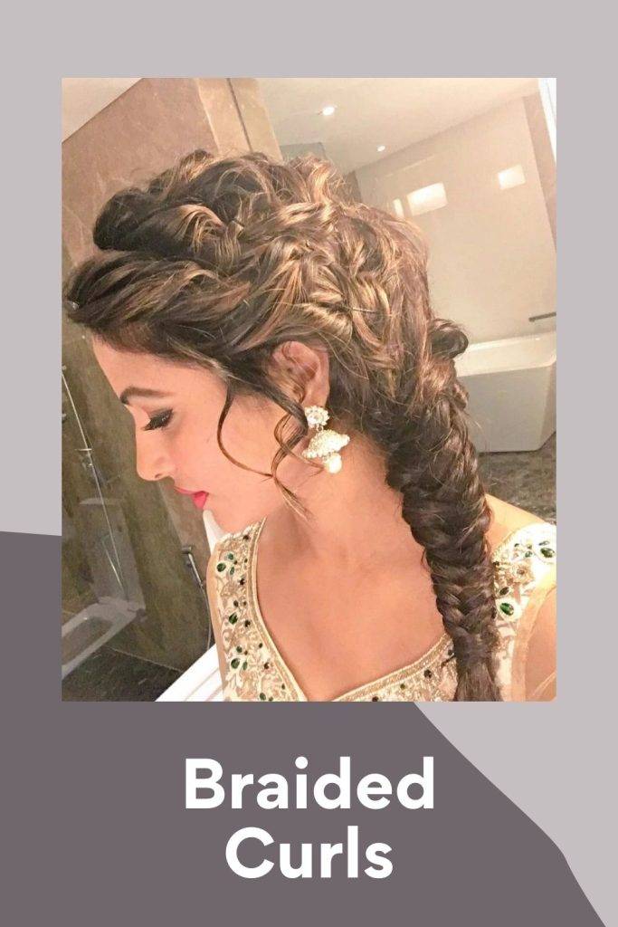 A girl in traditional dress and earing giving a side look of her braided  curls - hairstyles for tall girls