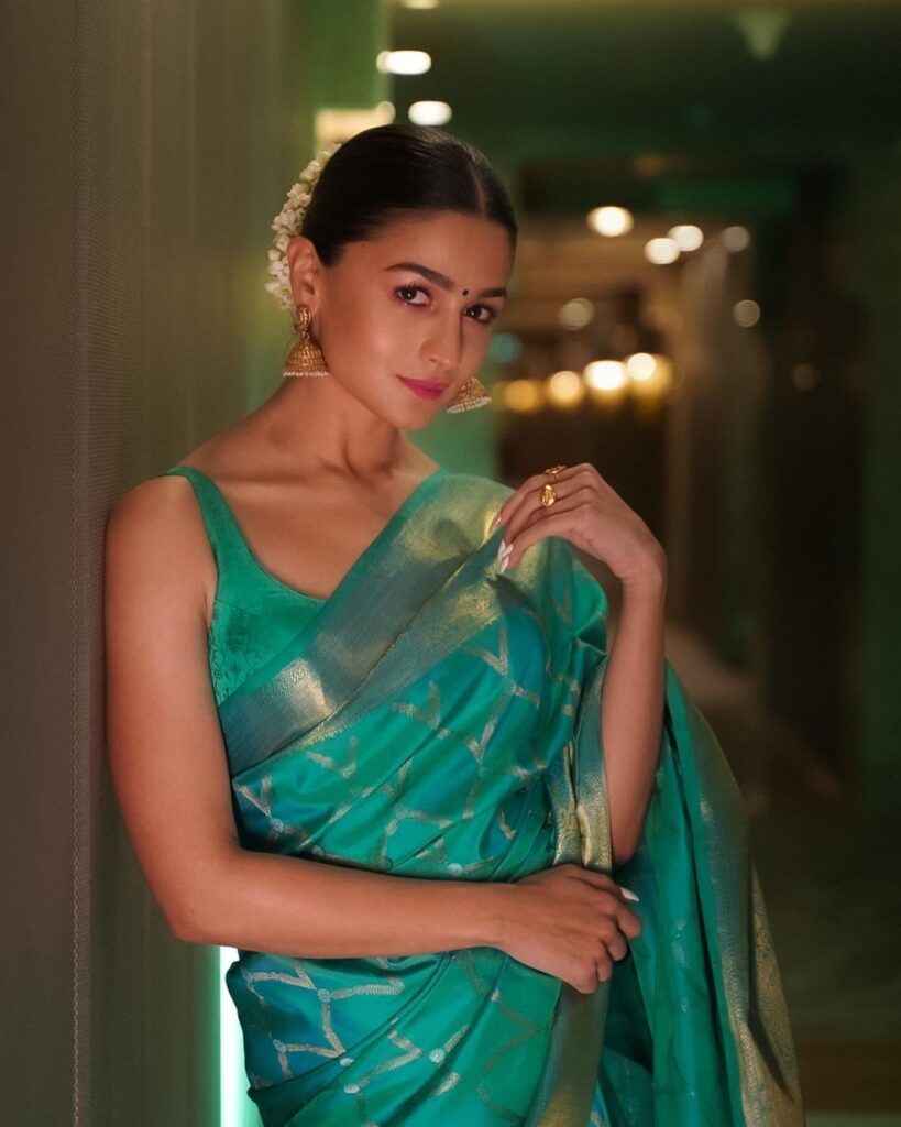Alia Bhatt in green saree and jhumka posing for camera and showing her Bun with Gajra hairstyle - Alia bhatt hairstyle