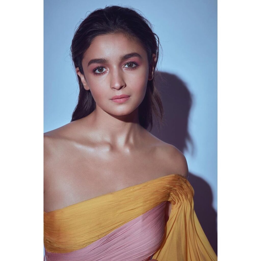 Alia Bhatt in golden and pink off shoulder gown with gelled hair - hair care regime