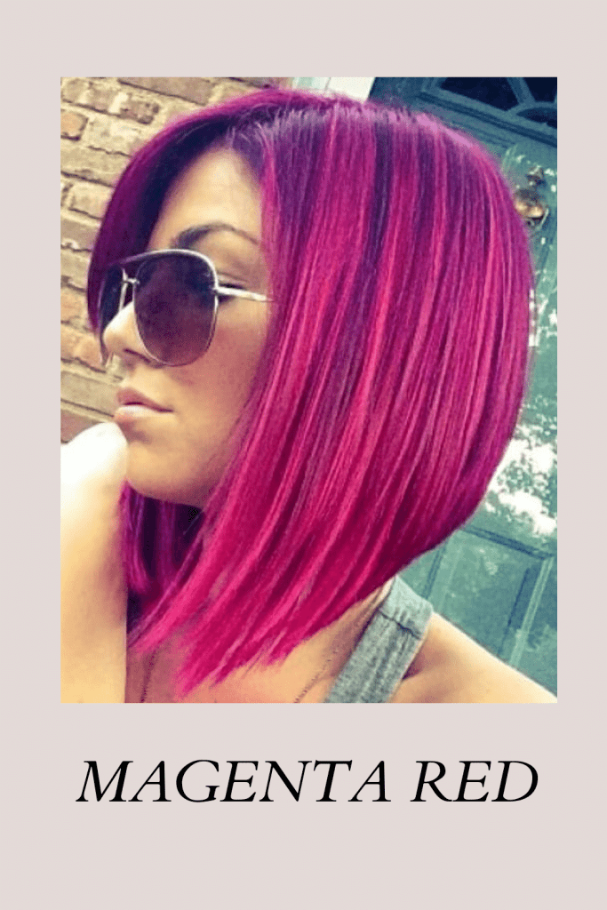 A girl in grey tank top and goggles showing the side view of her Magenta Red hair color - short hair