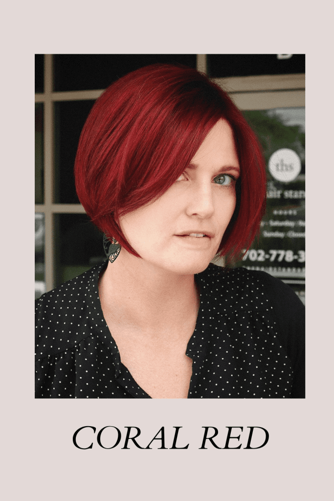 A girl in black and white polka dot dress posing for camera and showing her Coral Red hair color - face shape