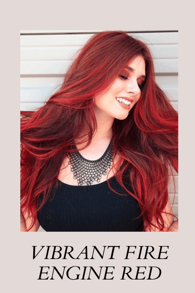 A girl in black round neck top and matching necklace showing her Vibrant Fire Engine Red hair color - indian skin tone