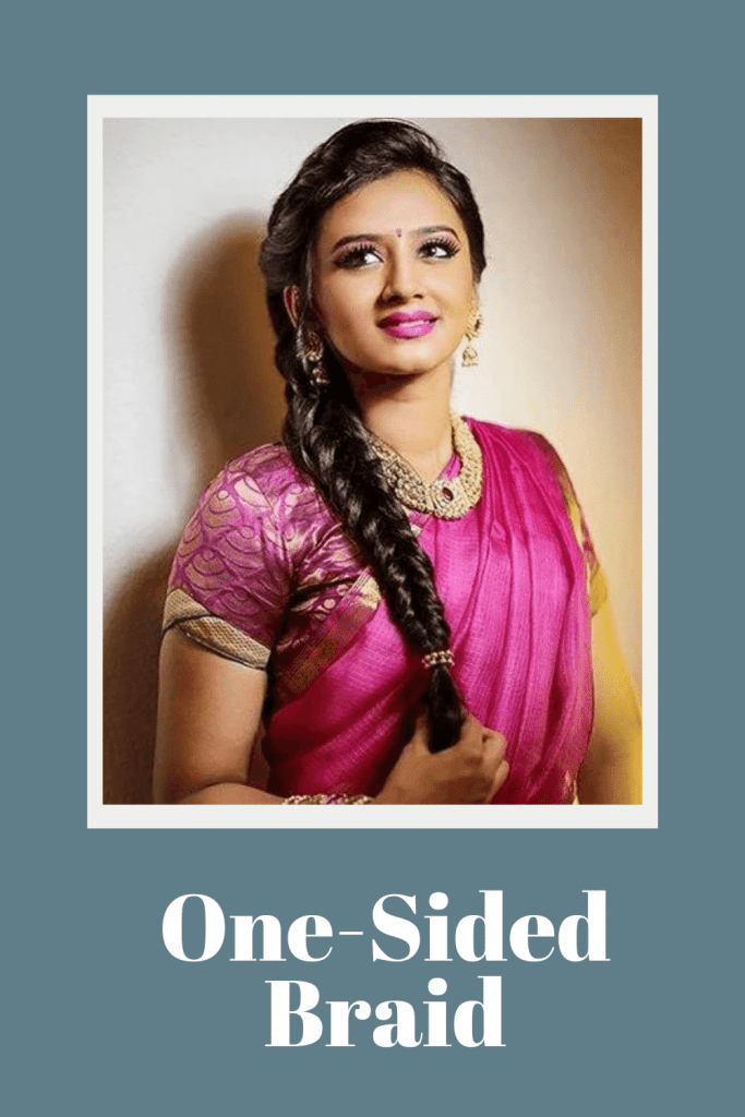 A girl in magenta color saree with heave necklace and one sided braid - braided hairstyles