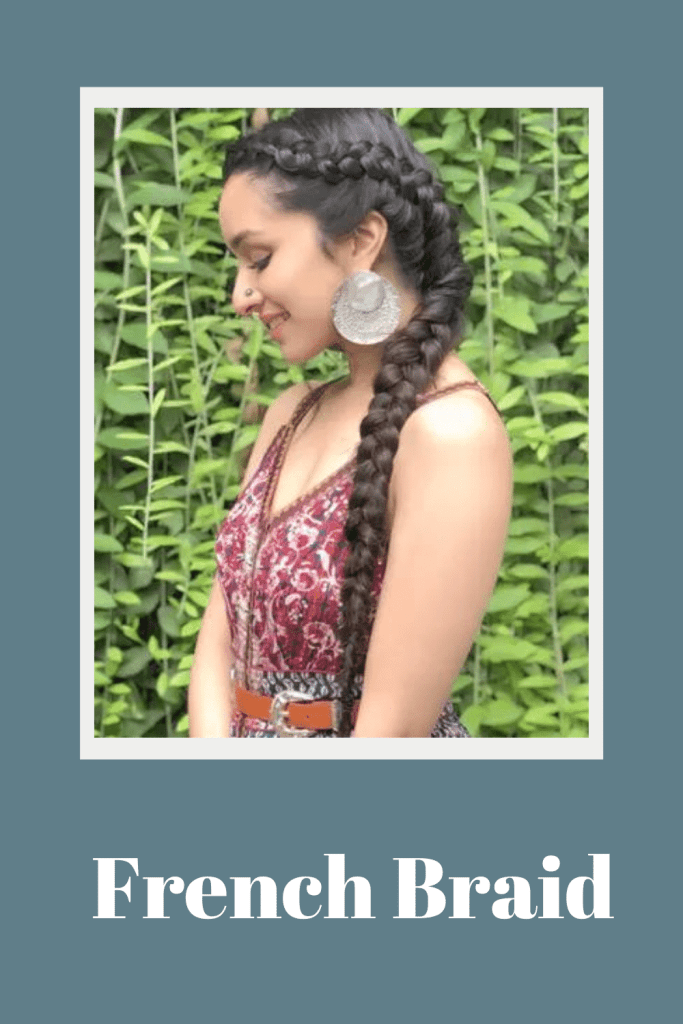 Shraddha Kapoor in printed strappy dress and bold earrings posing for camera and showing side view of her french braid - professional women hairstyles
