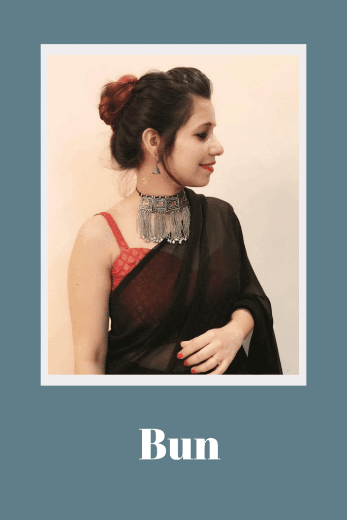 A girl in black saree with red blouse and oxidized jewellery showing the side view of her bun - hairstyles for tall girls 
