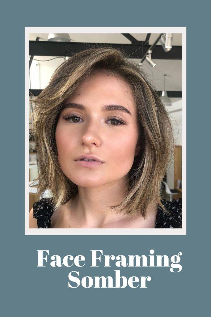 A girl in black floral top posing for a selfie and showing her Face-Framing Sombre hairstyle - hair care routine