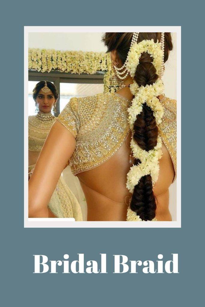 Sonam Kapoor in golden lehenga posing for camera and showing her bridal bride hairstyle - wedding hairstyles