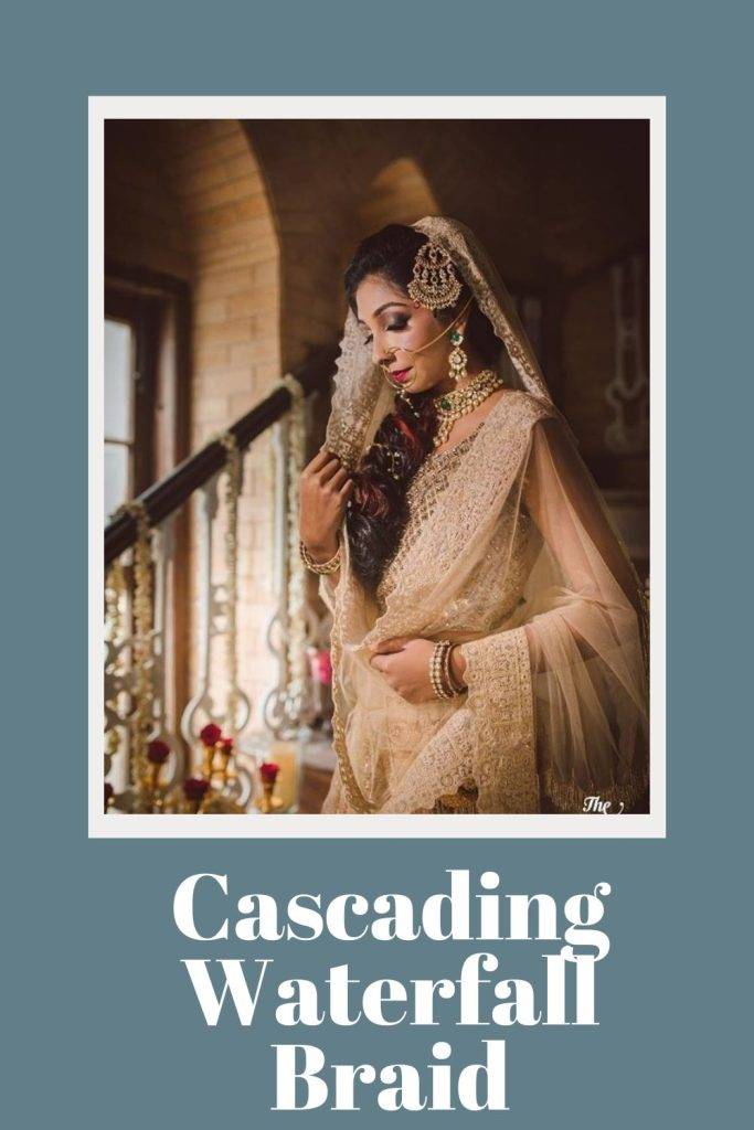 A girl in  golden lehenga posing for camera and showing the side view of her Cascading waterfall braid - bollywood actress bridal hairstyles