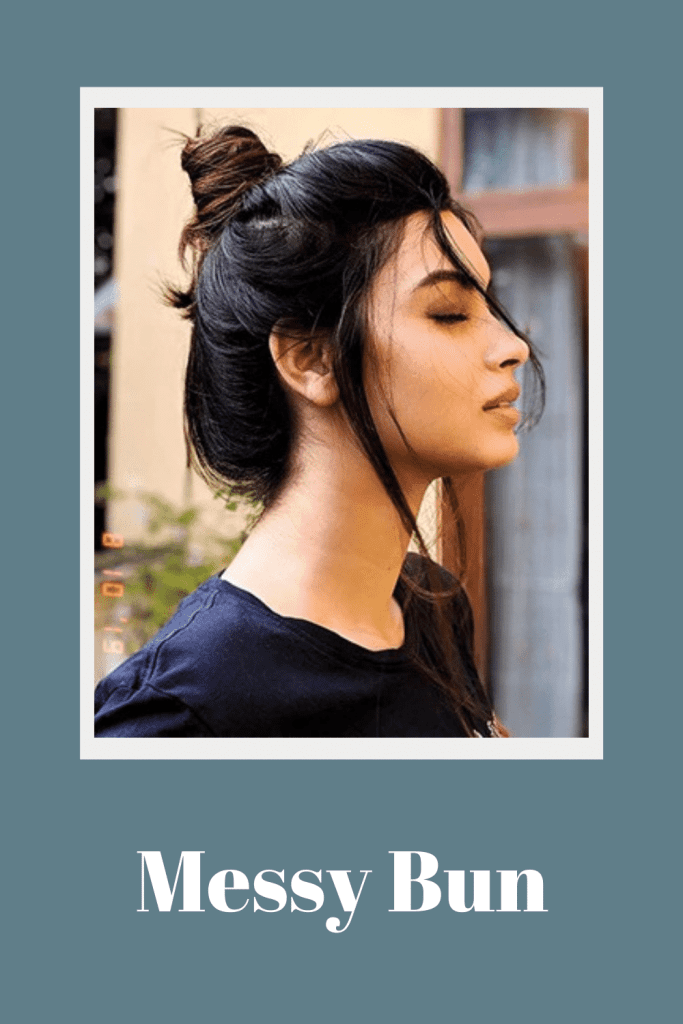 A girl in black top posing for camera and showing side view of her messy bun - latest hairstyles for women