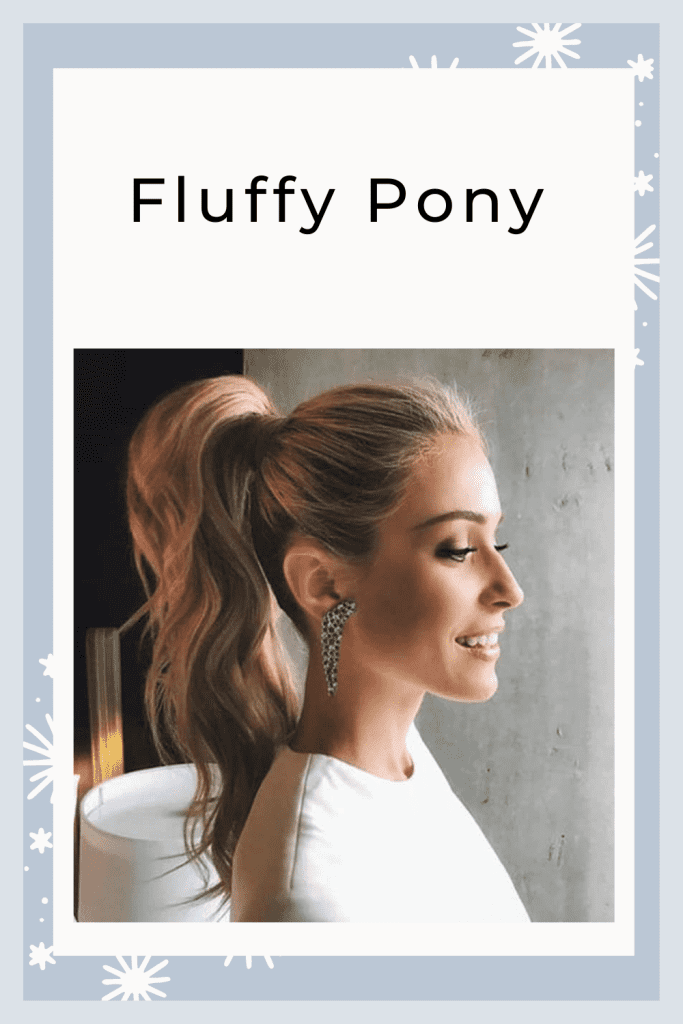 A girl in white top and long earring showing her Fluffy Pony - trending hair color