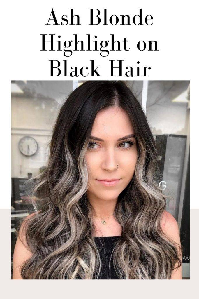 A girl in black tank top posing for camera and showing her Ash Blonde Highlight on Black Hair - trending hair color