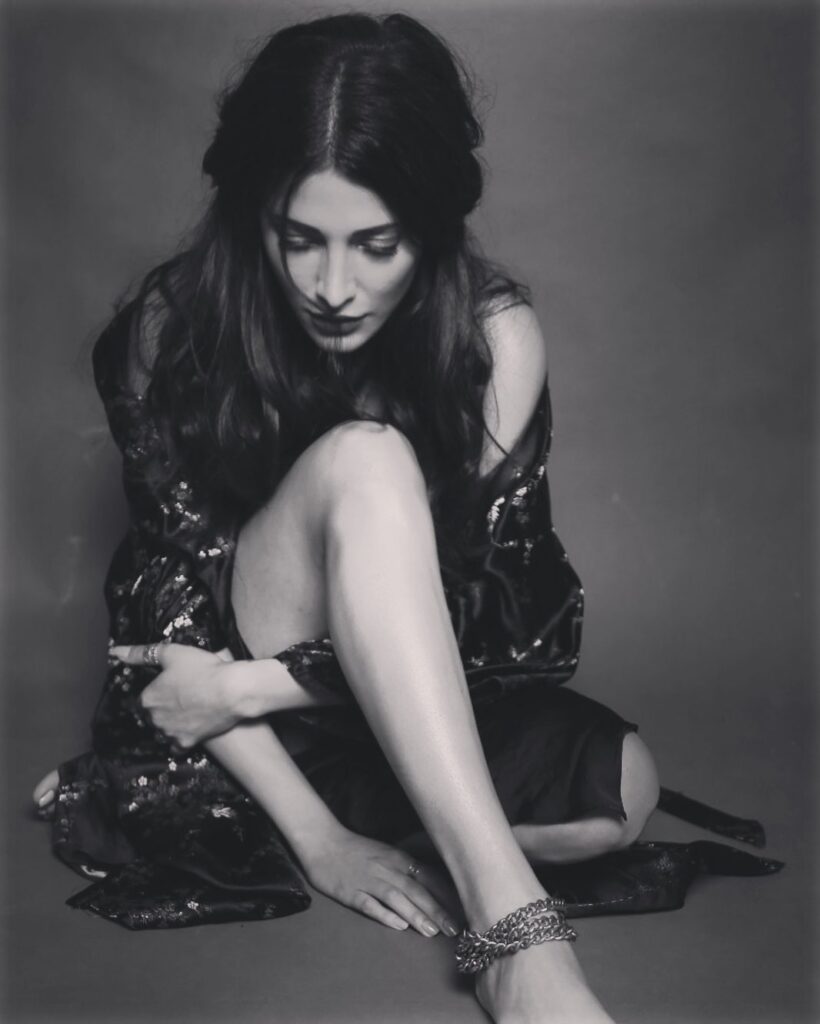 Shruti Haasan sitting on the floor and and showing her half tie hairstyle - short haircut