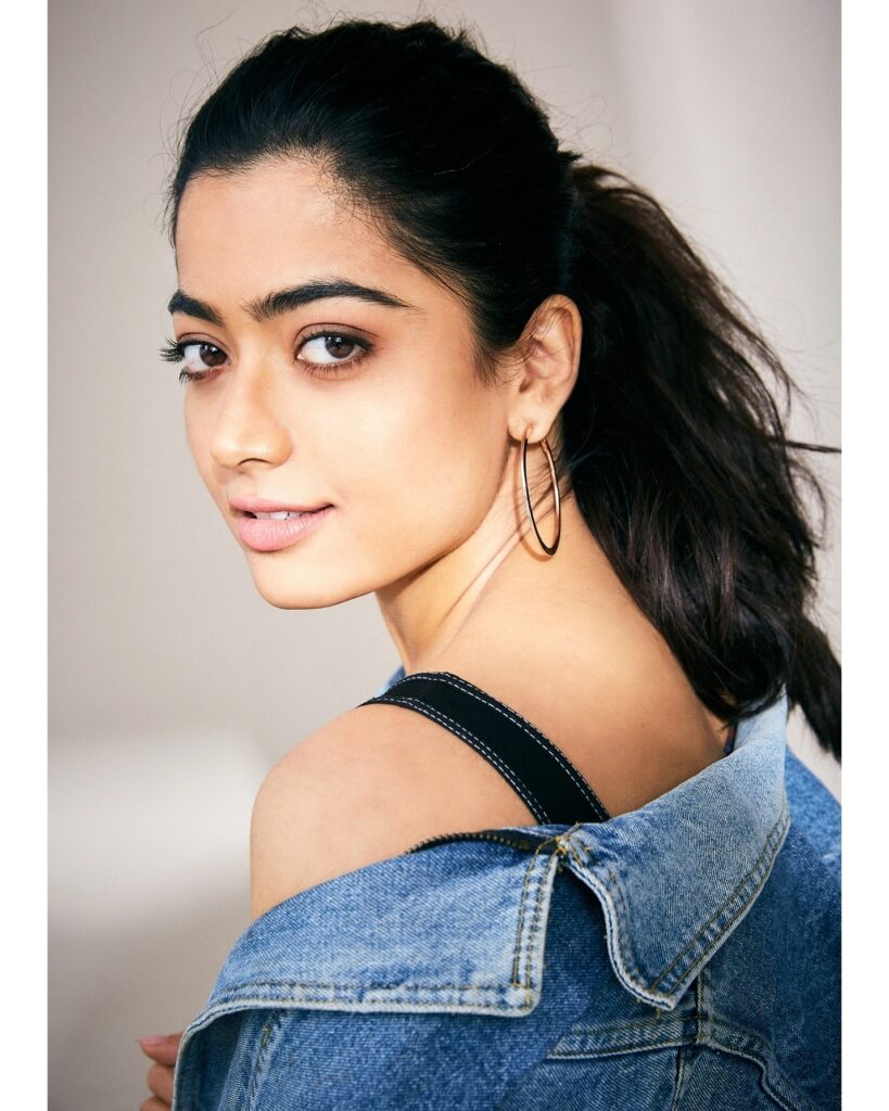 Rashmika Mandanain in blue denim jacket with hoops earrings showing the side view of her Messy Ponytail - hairstyles for thin girls