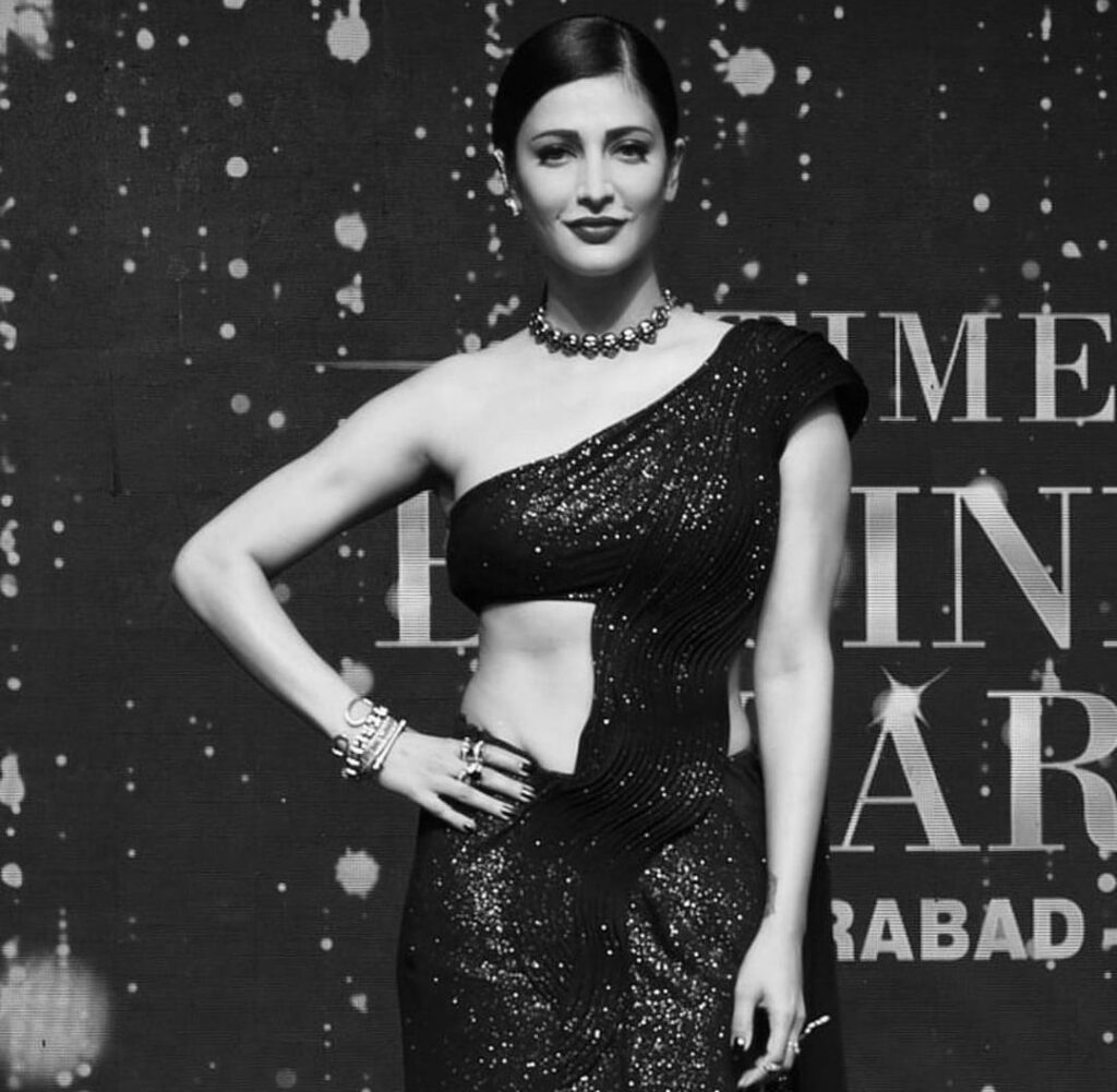 Shruti Haasan in one shoulder dress with accessories and side parted sleek low ponytail - hairstyles for thin girls