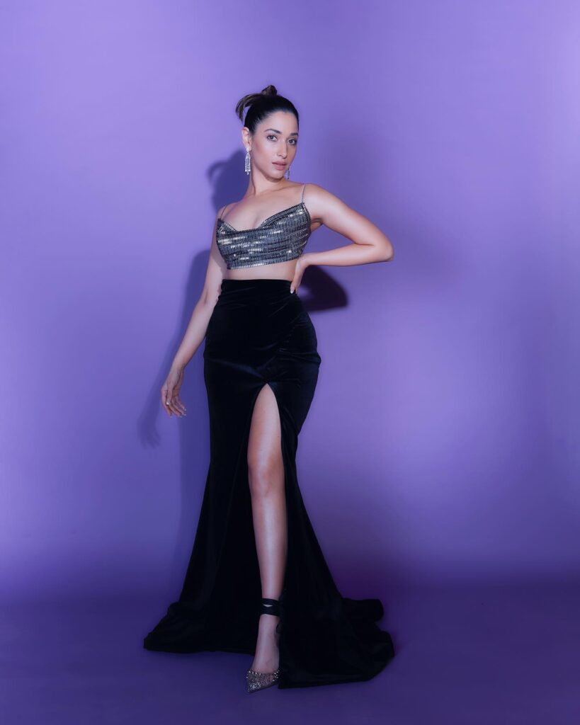 Tamannah Bhatia in high slit skirt and crop top posing for camera and showing her Knot Bun - hairstyles for tall girls