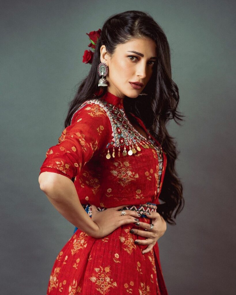 Shruti Haasan in red dress with silver earrings showing her side-swept curls - Shruti Haasan hairstyles