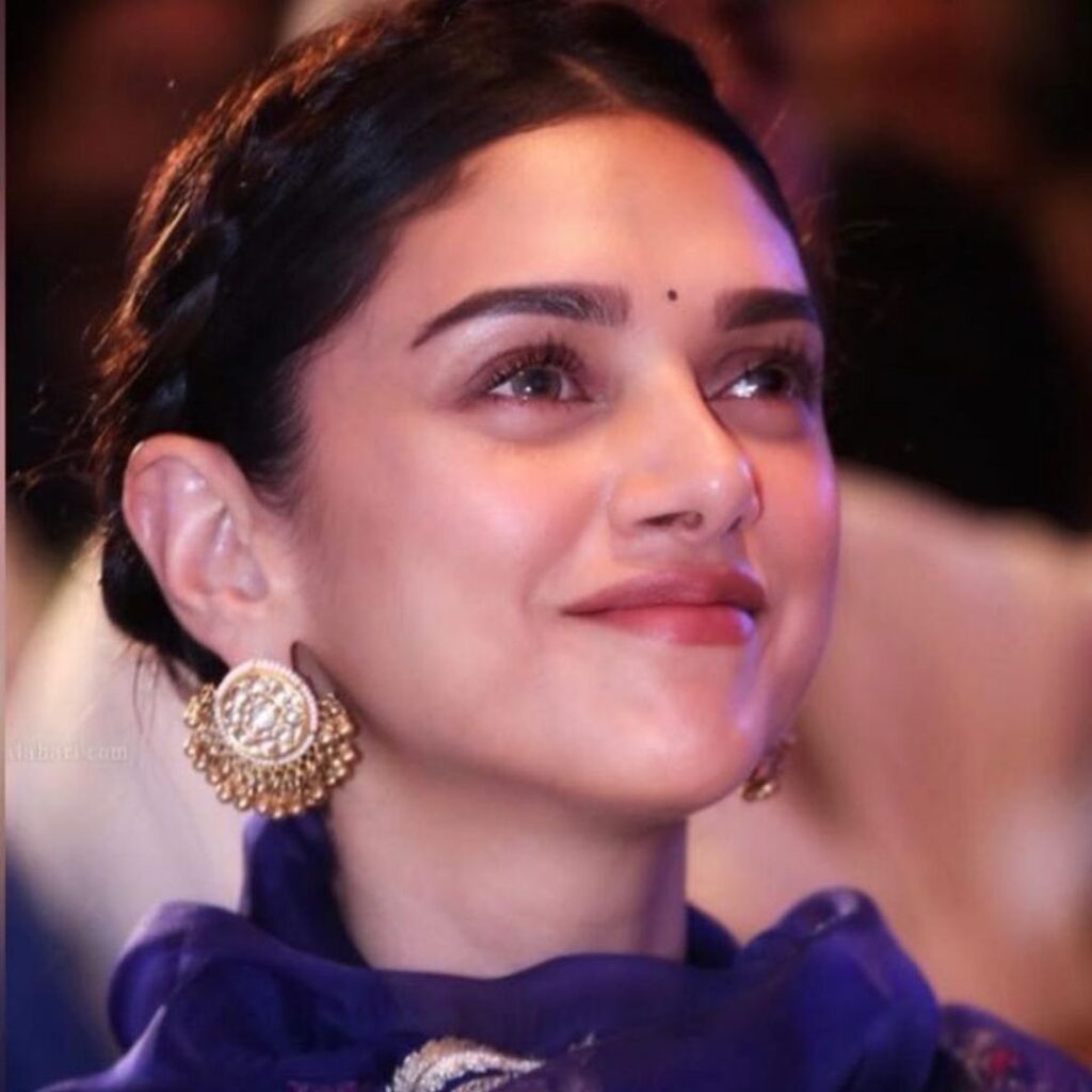 Aditi Rao Hydari in blue dress and golden earrings showing her neat tight bun - bollywood actresses latest hairstyles