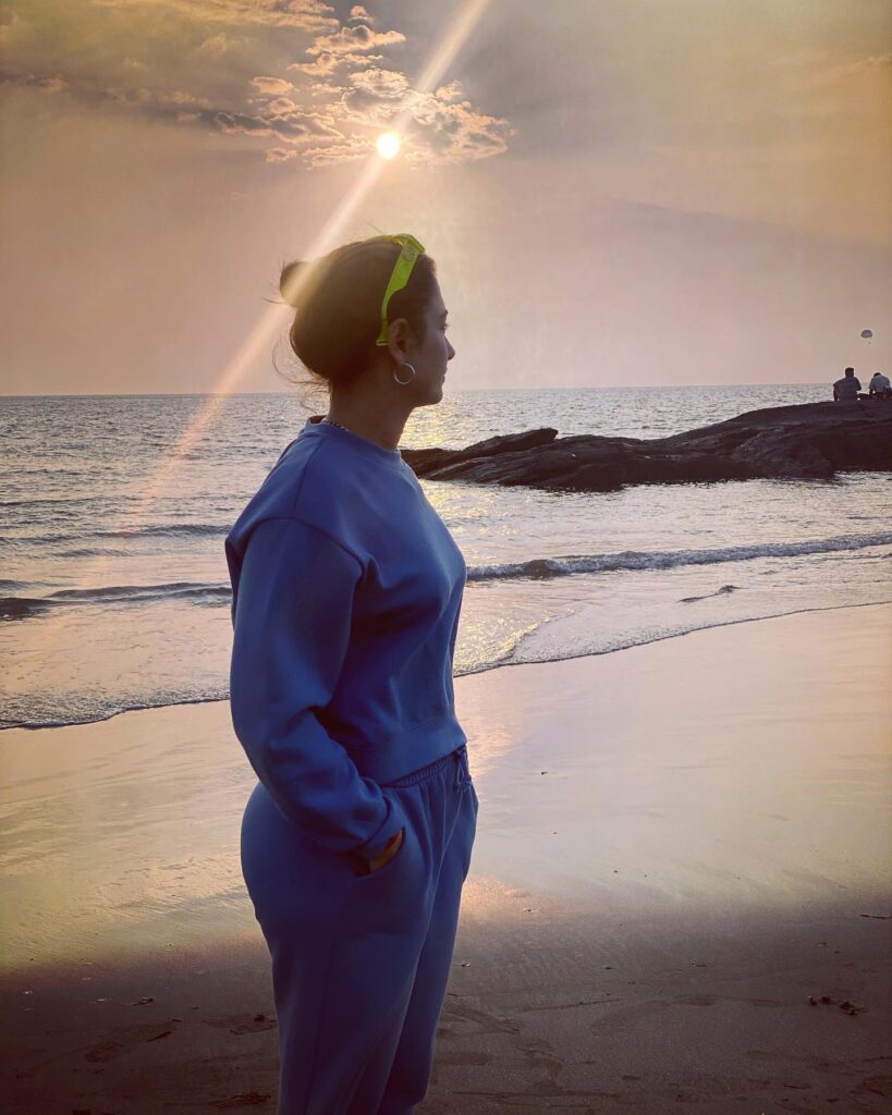Tamannah Bhatia in blue track suit standing on a beach - Tamannah Bhatia haircut name