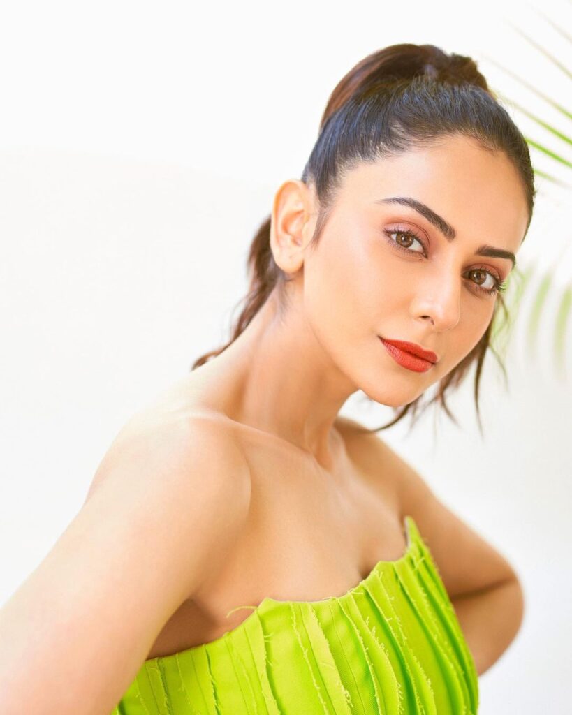 Rakul preet Singh in green color off shoulder dress and tight high ponytail posing for camera - hairstyles for tall girls