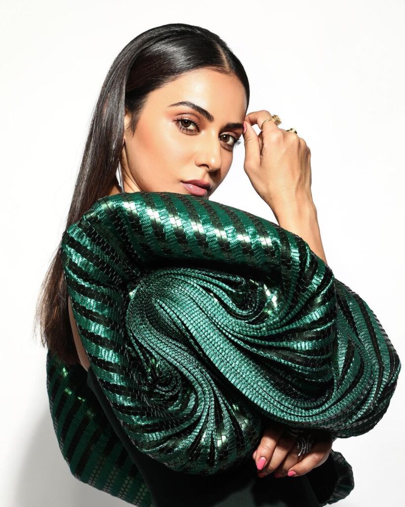 Rakul Preet Singh in bottle green color dress posing for camera and showing her Center parted Sleek Hair - hair color
