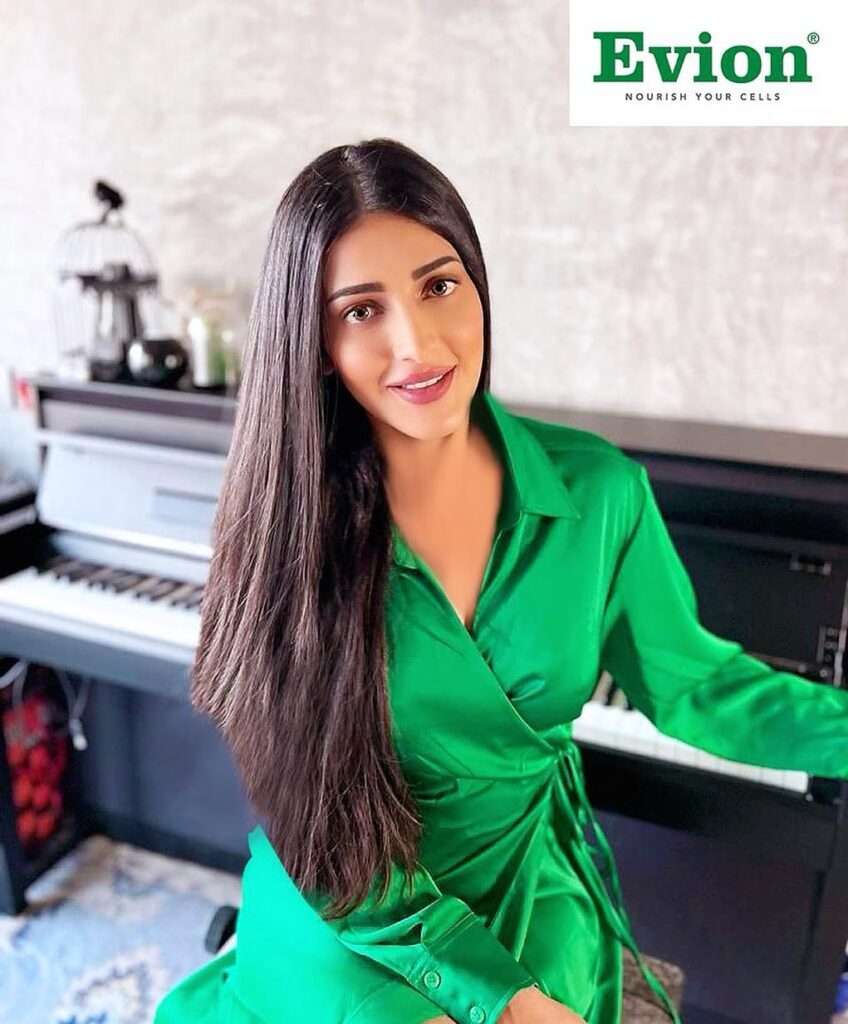 Shruti Haasan in green satin dress showing her straight and long hairstyle - hair color