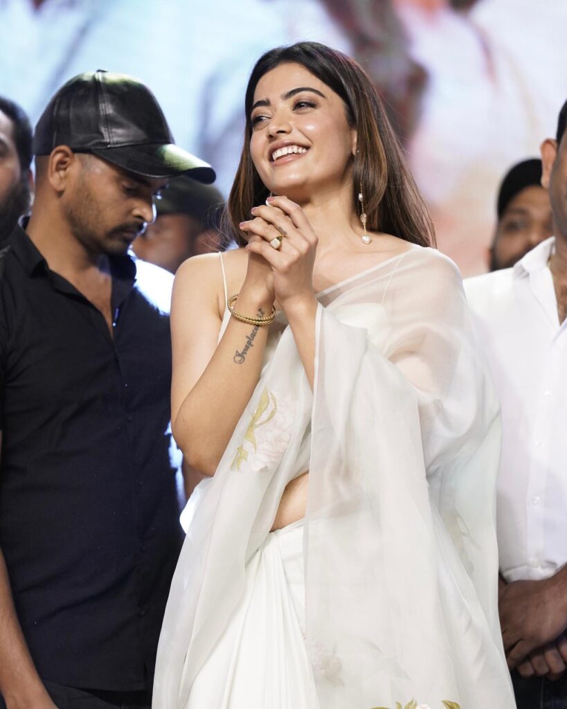 Smiling Rashmika in white saree and sleeveless blouse and Straight and Simple hair Straight and Simple hair - professional hairstyles