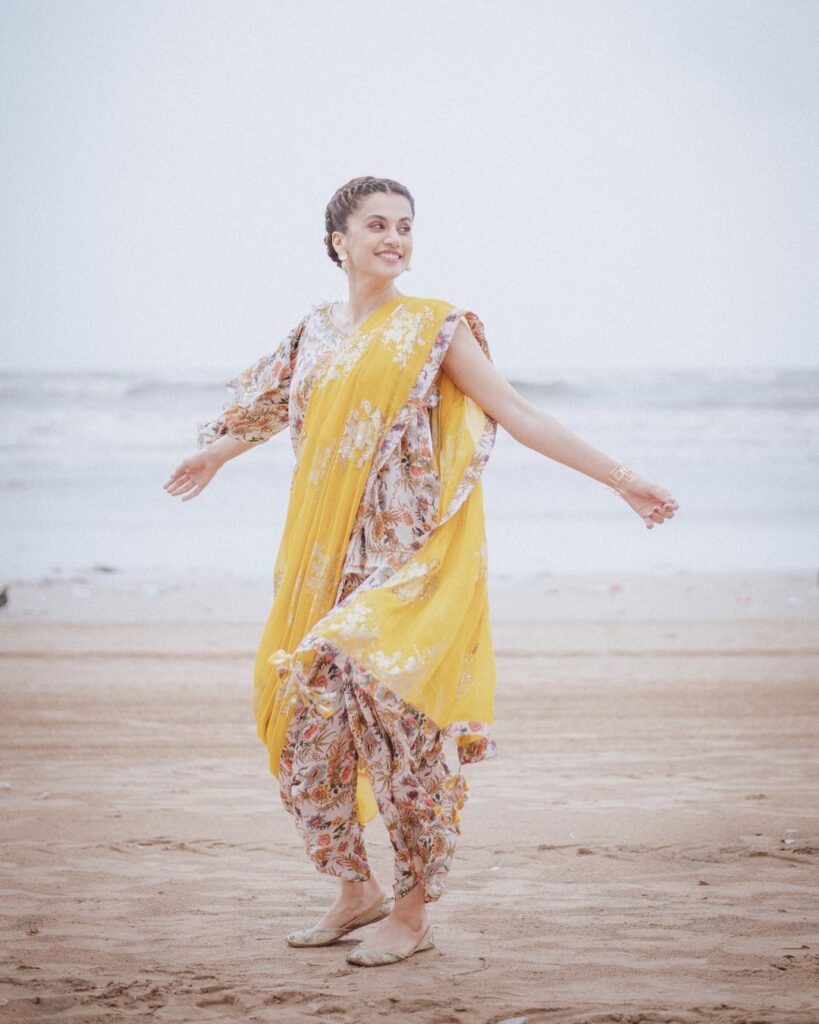 Tapsi Pannu in yellow floral suit posing on sea side - braided hairstyle