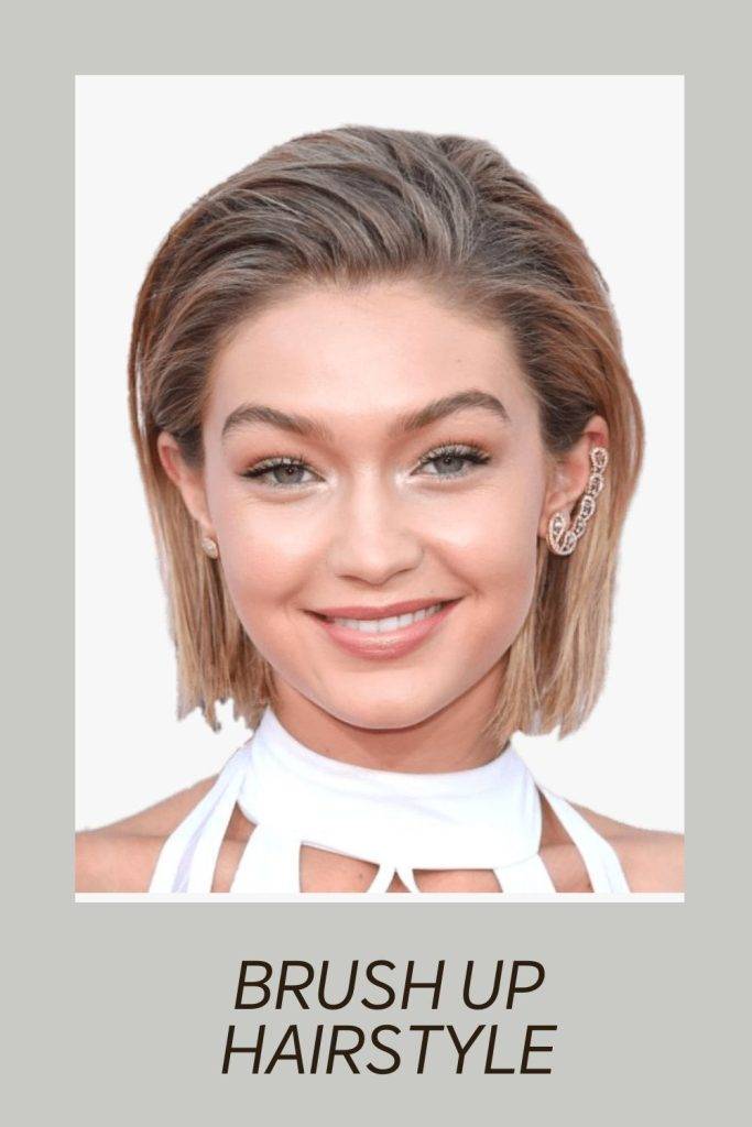 A smiling girl in white boat neck dress posing for camera and showing her Brush Up Hairstyle - celebrity hairstylist