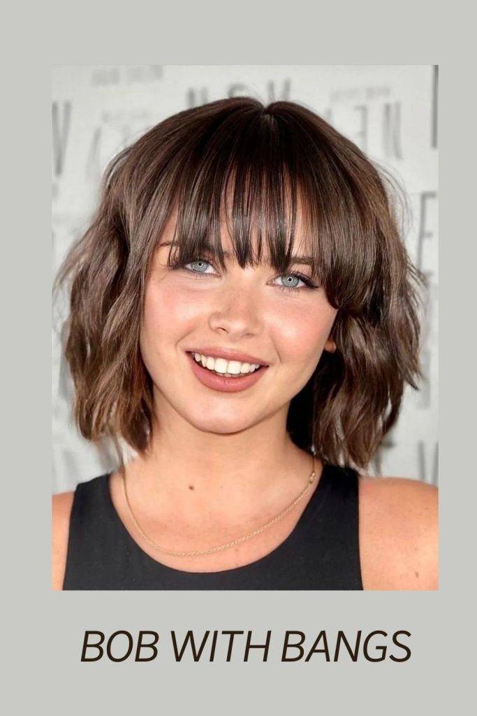 A smiling girl in black tank top showing her Bob With Bangs hairstyle - hairstyles for thin girls