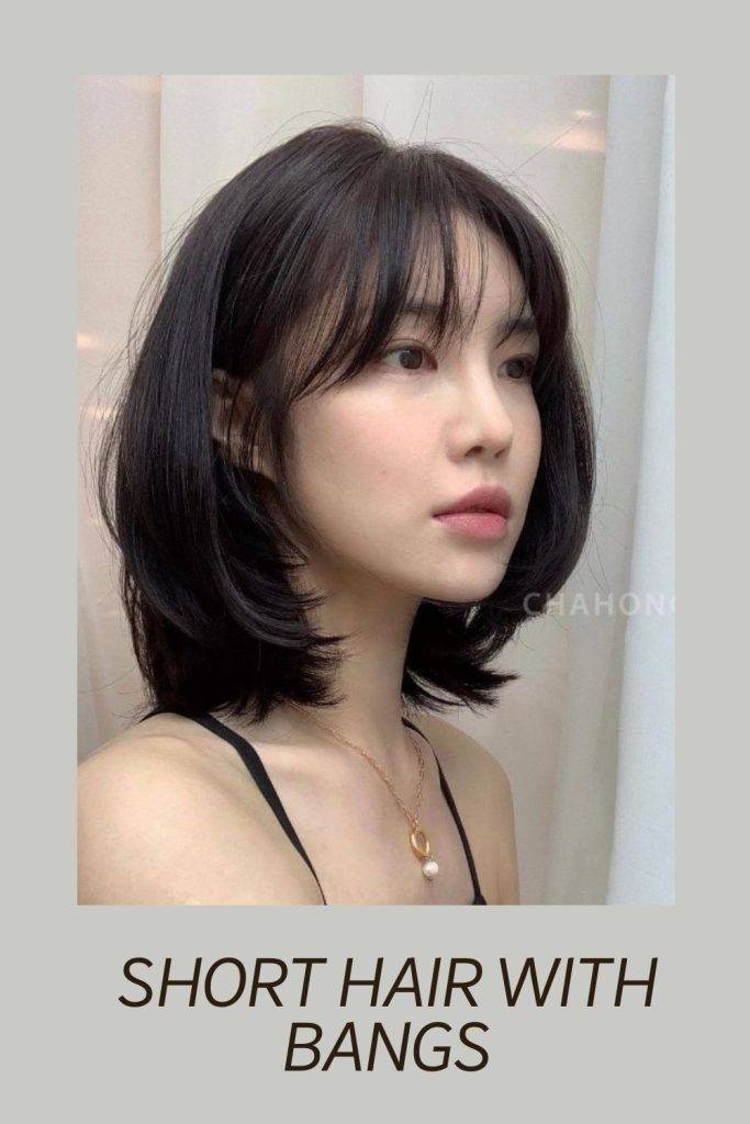 A girl in black strappy top showing the side view of her Short Hair With Bangs hairstyle - haircut name 