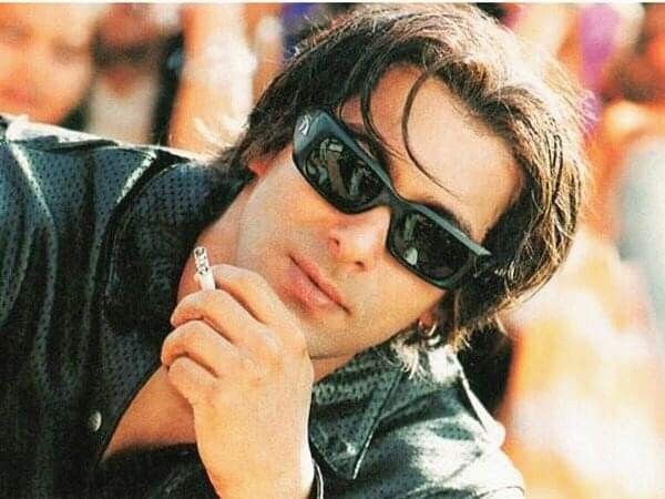 Salman Khan in black jacket with goggles posing for camera and showing his tere naam haircut - Salman Khan hairstyles in tere naam