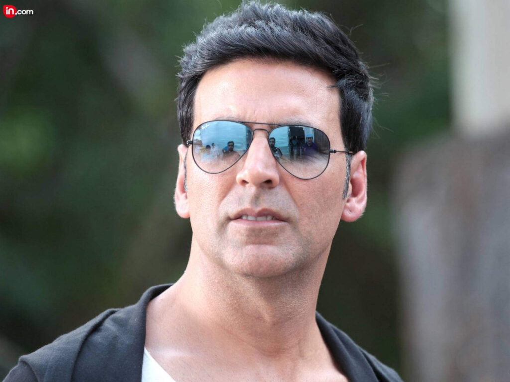Akshay Kuamr in black t-shirt and goggles posing for camera and showing his spikes hairstyle - akshay hairstyle