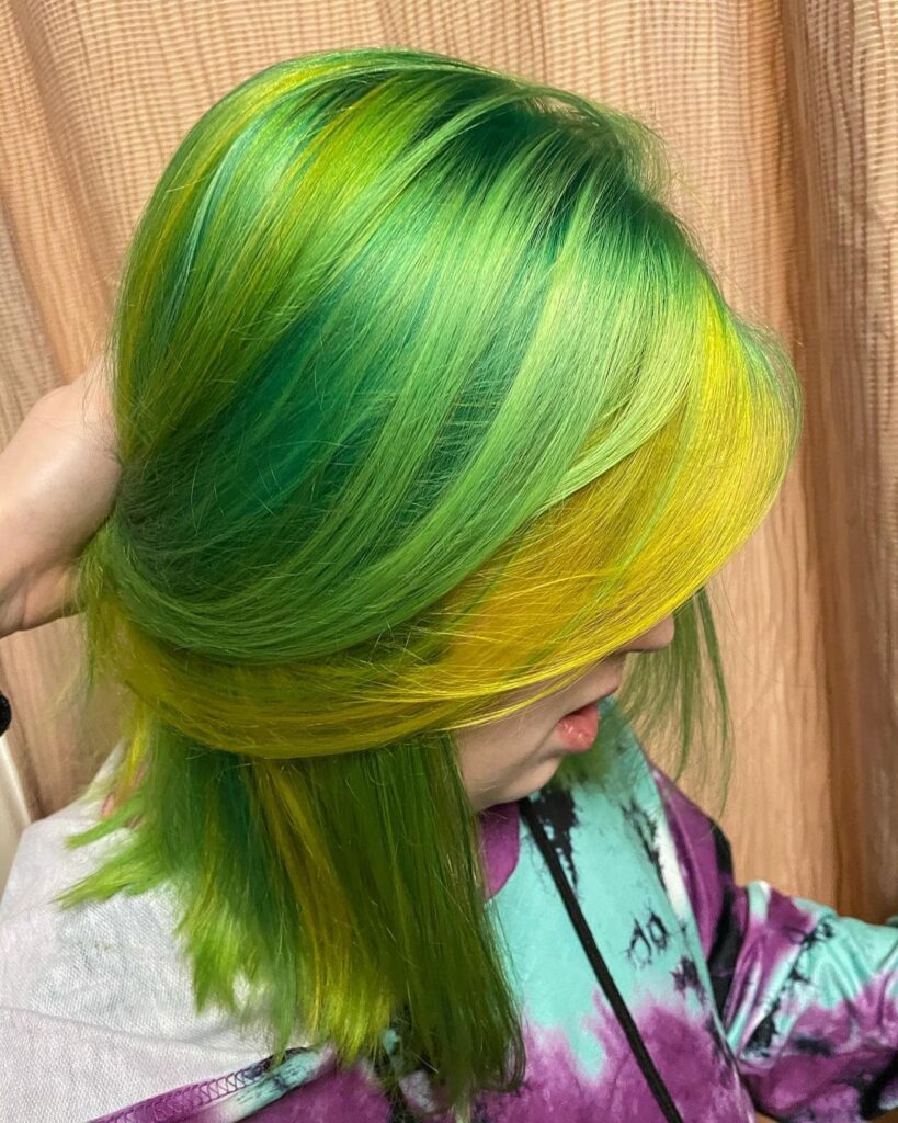 A girl showing the side view of her yellow-green hair color - green hair color
