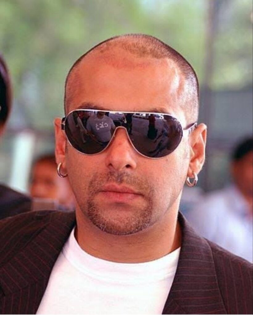 Salman Khan in black coat with white inner and goggles posing for  camera and showing his buzz cut hairstyle - hairstyles of Salman Khan