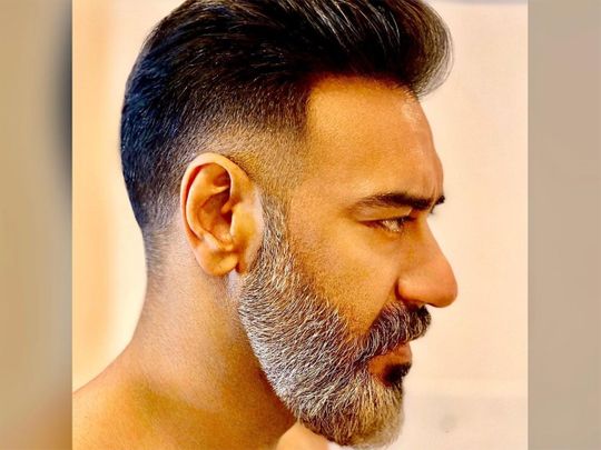 Ajay devgan posing for camera and showing the side view of his dapper Look - ajay devgan new movie hairstyle