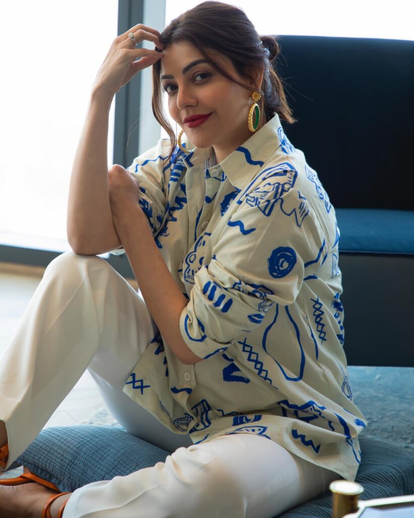 Kajal Aggarwal in white trouser with off white and blue printed shirt posing for camera - Kajal Aggarwal hairstyles
