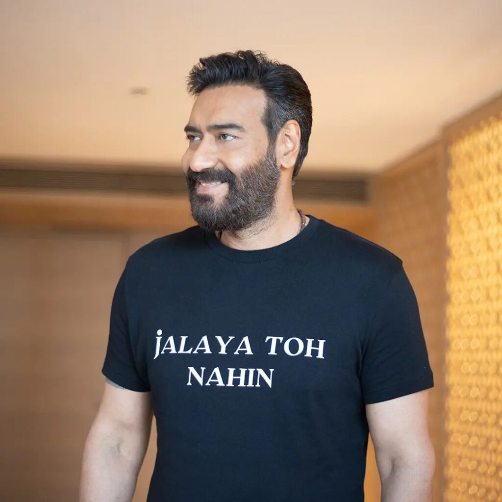 Smiling Ajay Devgan in black t-shirt showing his Spikes with Beard hairstyle - ajay devgan hairstyles