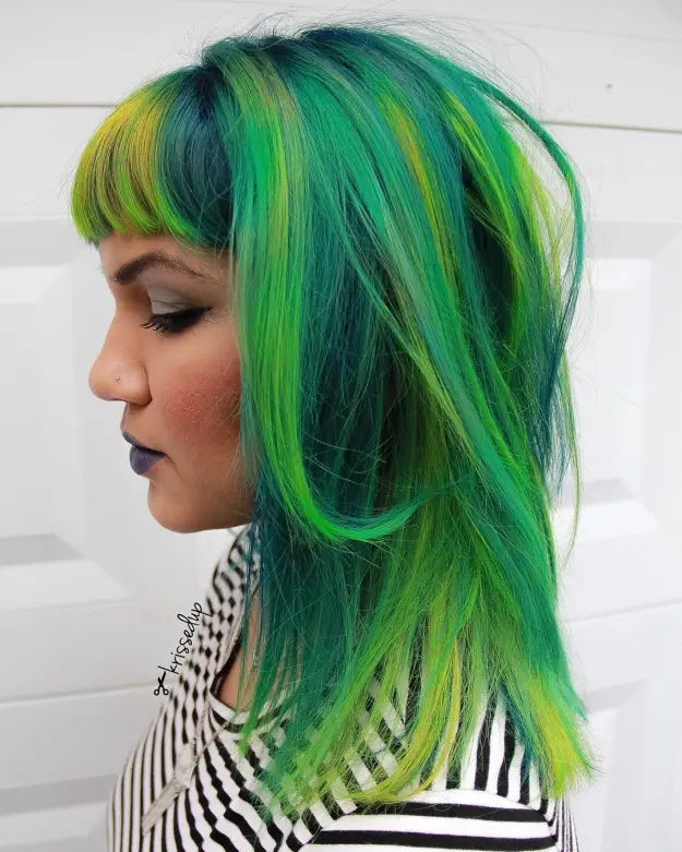 A girl in black and white strappy dress showing the side view of her Shades of green - green hair color ideas