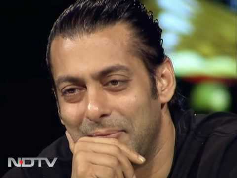 Salman Khan in black round neck t-ahi smiling and posing for camera - hairstyles of Salman Khan