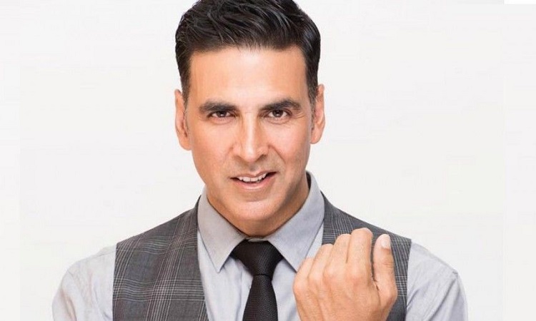 Akshay Kumar in grey shirt with check waist coat posing for camera and showing his Full Pompadour hairstyle -  akshay kumar hairstyle name