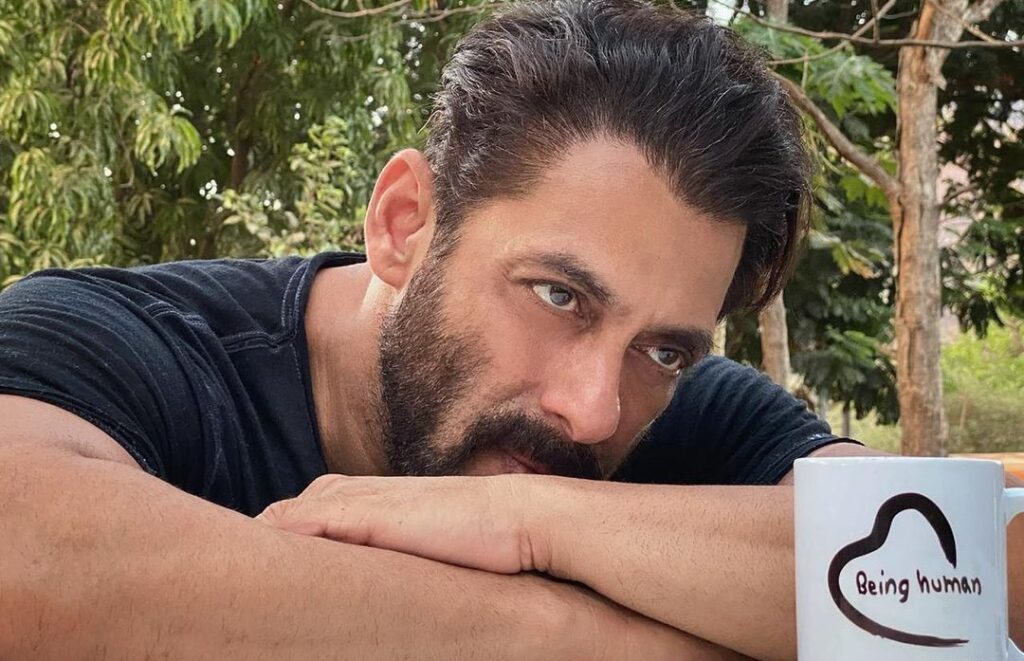 Salman Khan in black t-shirt posing for camera and showing his long bangs with beard - Salman Khan hairstyle photos