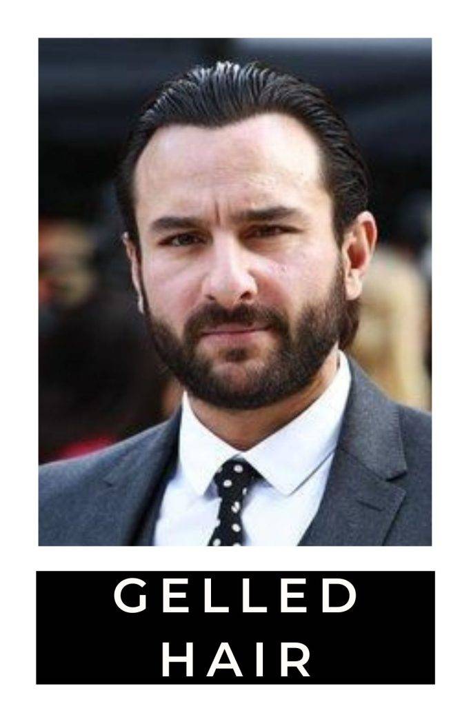 Saif Ali Khan in grey suit with white shirt posing for camera and showing his gelled hair - saif ali khan tandav look