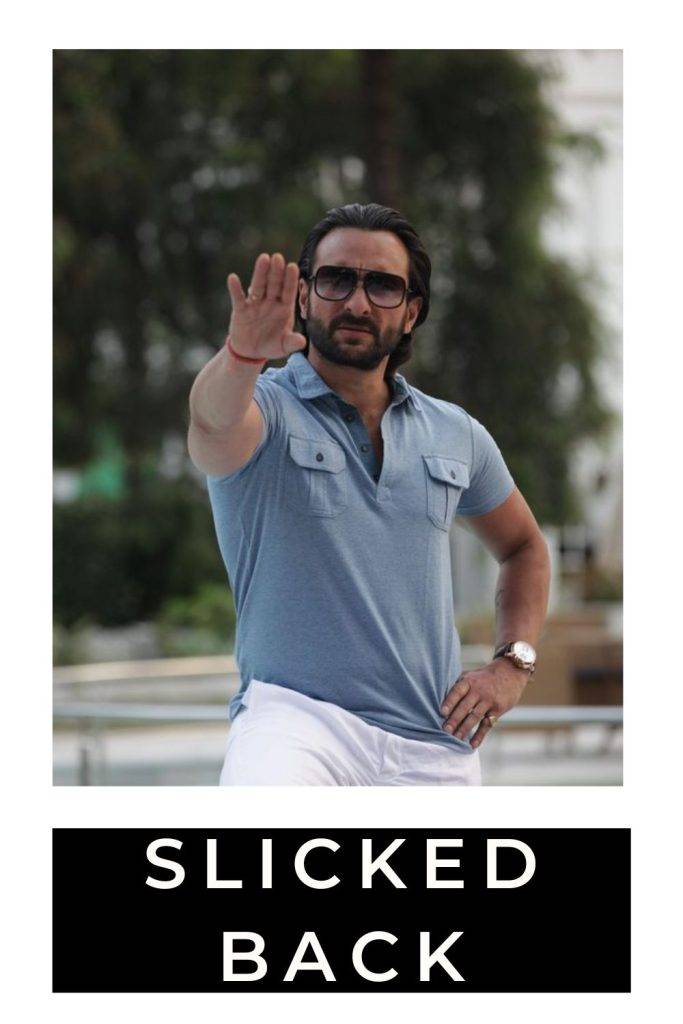 Saif Ali Khan in  white trouser with sky blue t-shirt and goggles posing for camera and showing his slicked back hairstyle - saif ali khan web series hairstyles