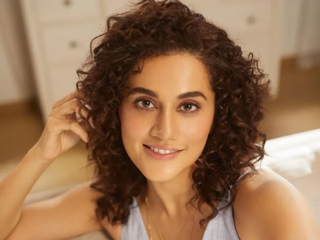 Tapsee Pannu in white cut sleeves dress posing for camera and showing her Rachel's Hair - hair cut for girls