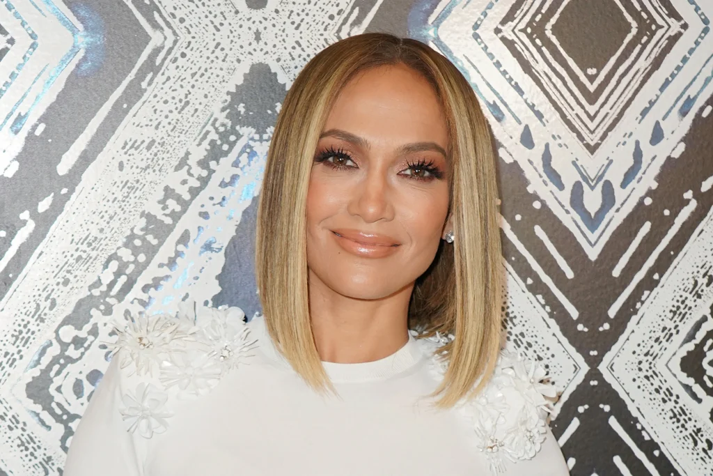 Smiling Jennifer Lopez in white dress posing for camera and showing her  Long Bob - hollywood actress haircut